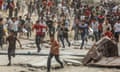 Palestinians gather to receive the humanitarian aid supplies airdropped into Khan Younis, Gaza, on 28 May.