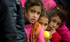 Children queue for food at a makeshift migrant and refugee camp on the Greek-Macedonian border.