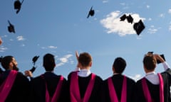 Graduates throwing their caps into the air.