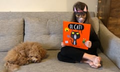 Flora Ferguson, pictured with dog Rosie, enjoying Oi Cat! by Kes Gray and Jim Field.