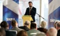 Humza Yousaf delivering a speech in front of a seated audience