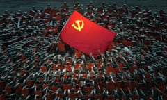 Performers dressed as rescue workers gather around the Communist party flag during a gala show ahead of the 100th anniversary of the founding of the Chinese Communist party in Beijing.