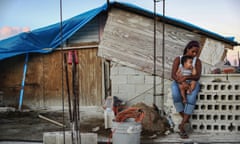 *** BESTPIX *** Puerto Rico Marks Holiday Season Amidst Slow Hurricane Recovery<br>SAN ISIDRO, PUERTO RICO - DECEMBER 23: Mother Isamar holds her baby Saniel, 9 months, at their makeshift home, under reconstruction, after being mostly destroyed by Hurricane Maria, on December 23, 2017 in San Isidro, Puerto Rico. Their neighborhood remains without electricity. Barely three months after Hurricane Maria made landfall, approximately one-third of the devastated island is still without electricity. While the official death toll from the massive storm remains at 64, The New York Times recently reported the actual toll for the storm and its aftermath likely stands at more than 1,000. A recount was ordered by the governor as the holiday season approached. (Photo by Mario Tama/Getty Images) *** BESTPIX ***