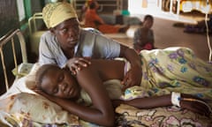 A mother cares for her daughter suffering from malaria in a hospital in Amuria, Uganda