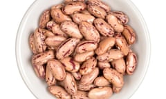 Pinto beans in white bowl isolated on white background