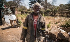 A zama zama prepares to go underground in Durban Deep, an abandoned Victorian-era gold mine.