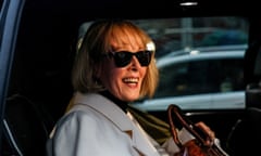 a woman in a white coat sits in a car