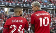 Toronto FC's Lorenzo Insigne (24) talks with teammate Federico Bernardeschi (10) before an MLS soccer match against Charlotte FC in Toronto, Saturday July 23, 2022. (Chris Young/The Canadian Press via AP)