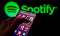Spotify logo displayed on a smart phone with Spotify seen on screen