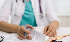 Close-up of a doctor with paper on a desk