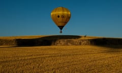 A hot air balloon flies over the city of Igualada during an early flight