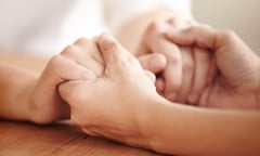 Helping a friend in need<br>Hands holding each other over a table