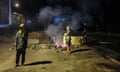 Young men stand by a roadblock in the district of Auteuil in New Caledonia on 19 June.