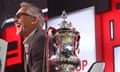 Gary Lineker in a TV studio alongside the FA Cup.