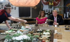 Donald Trump looks suspiciously at a plate of food from a chef as he and Shinzo Abe and their wives have a couples dinner in Tokyo in 2019. 