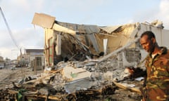 A Somali soldier walks near destroyed buildings after a suicide car bomb on Friday night in Mogadishu.