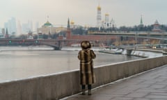 A woman looking at the cityscape of Moscow from a bridge