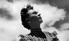 seen from below, Frida leaning back, head up, sunlit clouds behind her