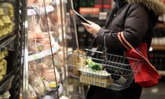 A customer browses products at a chilled fresh food cabinet inside a branch of Marks &amp; Spencer.