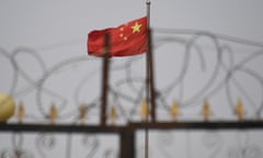 FILES-US-CHINA-XINJIANG-RIGHTS-TRADE<br>(FILES) This file photo taken on June 4, 2019 shows the Chinese flag behind razor wire at a housing compound in Yangisar, south of Kashgar, in China’s western Xinjiang region. - The US will seize all imports of tomato and cotton products from China’s Xinjiang region due to the use of forced labor, the Customs and Border protection agency announced on January 13, 2021. (Photo by GREG BAKER / AFP) / RESTRICTED TO EDITORIAL USE - MANDATORY CREDIT AFP PHOTO / BADUNG POLICE - NO MARKETING - NO ADVERTISING CAMPAIGNS - DISTRIBUTED AS A SERVICE TO CLIENTS (Photo by GREG BAKER/AFP via Getty Images)