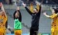 Mark Bonner and his Cambridge United players celebrate in front of their fans after their stunning win at Newcastle