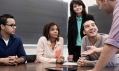 Students talking in a classroom.