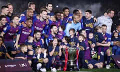 Barcelona’s players and their children celebrate after securing the La Liga title.