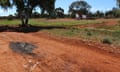 The patch of oil marking where the Nissan Navara came to rest, looking back across Gribble Creek Reserve toward Clancy Street and a tree that had been set up as a memorial to Elijah Doughty.