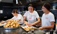 Bake for Gaza - Linda Taber, Karima Hazim and Sivine Tabbouch evenly spread the ma'moul for cooling before icing and boxing at LeBlack Owl Cafe, 2024.