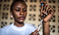 Nurse fills syringe with vaccine