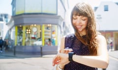 Woman using smart watch on street