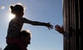 MEXICO-US-BORDER-PRAYER<br>A girl from Anapra, a neighbourhood on the outskirts of Ciudad Juarez in Mexico, touches hands with a person on the United States through the border fence, during a prayer with priests and bishops from both countries to ask for the migrants and people of the area, on February 26, 2019. - Built two years ago, the Anapra fence is one of several reinforced border barriers that the administration of US President Donald Trump calls the first sections of the wall. (Photo by Herika MARTINEZ / AFP)HERIKA MARTINEZ/AFP/Getty Images