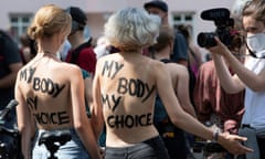 Demonstrators with the lettering 'My body my choice' painted on their back take part in a bicycle protest for the 'equality of all bodies, against discrimination of women's bodies in public space' in Berlin, on July 10, 2021.