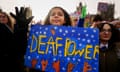 Young people and poster saying 'Deaf Power' with deaf signs on it