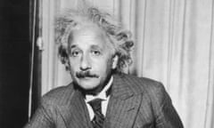 Albert Einstein<br>Portrait of physicist Albert Einstein, sitting at a table holding a pipe, circa 1933. (Photo by Lambert/Keystone/Getty Images)