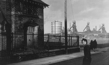 A black and white image of the Clay Lane ironworks with a child in the foreground.