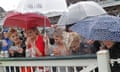 Racegoers struggled with the wind and rain during day one of the Grand National meeting at Aintree.