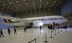 FILE - In this July 27, 2020 file photo, Mexican President Andres Manuel Lopez Obrador, center left, waves to the press as he arrives to give his daily, morning press conference in front of the former presidential plane at Benito Juarez International Airport in Mexico City. After almost 4 1/2 years of trying, Mexico's president says he has finally sold the unwanted presidential jet, to the former Soviet republic of Tajikistan. (AP Photo/Marco Ugarte, File)