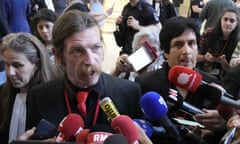 Eagles of Death Metal singer Jesse Hughes, left, and guitarist Eden Galindo, face reporters outside court in Paris.