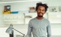 Young African Businessman Standing By His Desk<br>Smiling young African businessman standing by his desk.