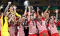 Kostas Fortounis lifts the trophy high as he and his teammates, and owner Evangelos Marinakis, celebrates Olympiacos’ Europa Conference League triumph over Fiorentina.