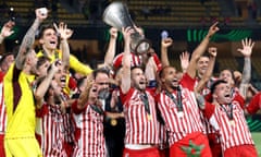 Kostas Fortounis lifts the trophy high as he and his teammates, and owner Evangelos Marinakis, celebrates Olympiacos’ Europa Conference League triumph over Fiorentina.