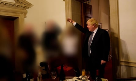 A photograph of Boris Johnson with a drink at a gathering in 10 Downing Street on the departure of a special adviser