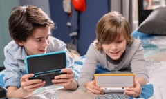 Nintendo 2DS XL portable games console in the hands of two boys