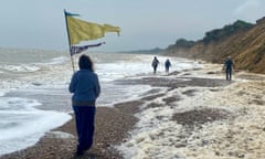 Kevin Rushby's walk in Suffolk, spume generated by algae on the coast south of Lowestoft as walkers pass