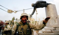 US Marines arrive to help Iraqi civilians pull down a statue of Saddam Hussein, in Baghdad, Iraq.