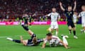 Stuart Armstrong tumbles to the ground after the challenge of Hungary’s Willi Orban