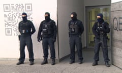 Police guard a residential building in Berlin after a raid in connection with the Fussilet 33 mosque