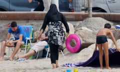 A Muslim woman wears a burkini