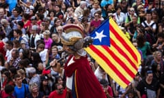 A giant or capgross holding and independence flag, is carried in the middle of a crowd in Sant Jaume square in Barcelona, Spain, Sunday, Sept. 24, 2017. Grassroots groups driving Catalonia’s independence movement say they have started distributing one million ballots to be used in a referendum on secession that the Spanish government has vowed to stop. (AP Photo/Emilio Morenatti)